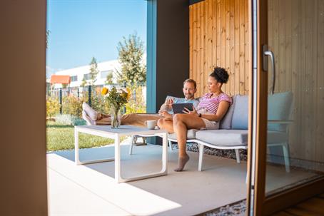husband and wife relaxing on their patio